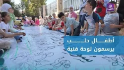 Children in Aleppo paint a collective mural for the International Day of Peace