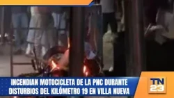 PNC motorcycle set on fire during riots at kilometer 19 in Villa Nueva